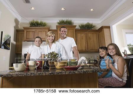 Portrait of family having breakfast in the kitchen View Large Photo Image Stock Photo - Portrait of family having breakfast in the kitchen. Fotosearch