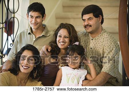 Portrait of family sitting together on stairs View Large Photo Image Stock Photo - Portrait of family sitting together on stairs. Fotosearch