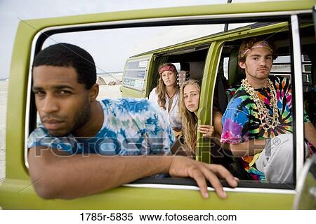 Stock Photography - Portrait of hippies sitting in a van. Fotosearch