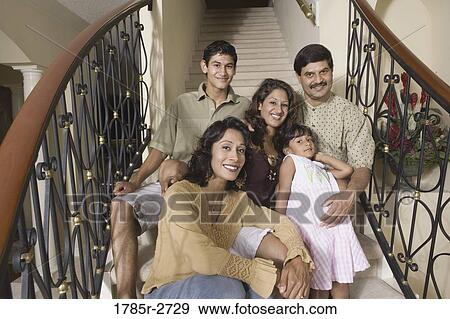 Portrait of Indian family sitting together on stairs View Large Photo Image Stock Photo - Portrait of Indian family sitting together on stairs. Fotosearch