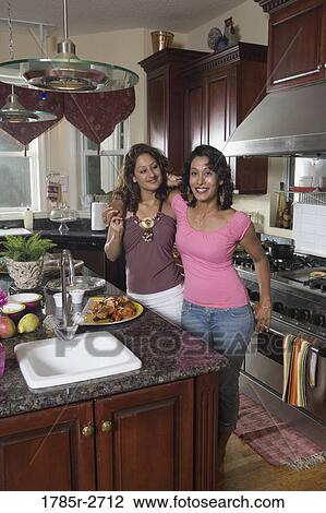 Portrait of Indian mother and daughter in kitchen View Large Photo Image Stock Image - Portrait of Indian mother and daughter in kitchen. Fotosearch