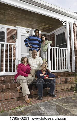 Portrait of interracial couple and family in front of house View Large Photo Image Stock Image - Portrait of interracial couple and family in front of house. Fotosearch