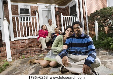 Portrait of interracial couple and family in front of house View Large Photo Image Stock Image - Portrait of interracial couple and family in front of house. Fotosearch