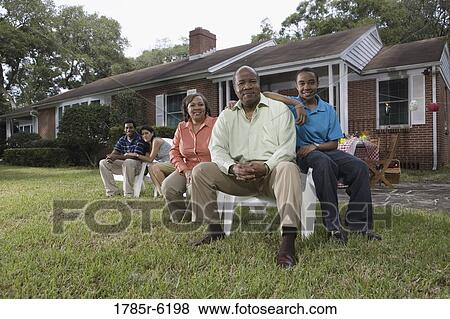 Portrait of interracial couple and family sitting in backyard View Large Photo Image Stock Photo - Portrait of interracial couple and family sitting in backyard. Fotosearch