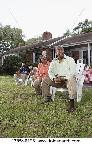 Portrait of interracial couple and parents relaxing in backyard View Large Photo Image Stock Photograph - Portrait of interracial couple and parents relaxing in backyard. Fotosearch