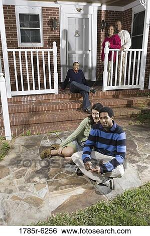 Portrait of interracial couple and family in front of house View Large Photo Image Stock Photograph - Portrait of interracial couple and family in front of house. Fotosearch