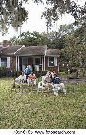 Portrait of interracial couple and family relaxing in backyard View Large Photo Image Stock Photography - Portrait of interracial couple and family relaxing in backyard. Fotosearch