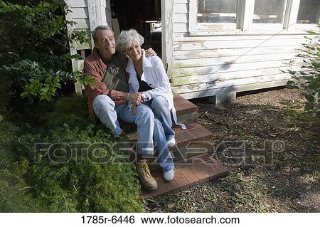 Portrait of mature couple sitting on doorstep of dilapidated tool shed View Large Photo Image Stock Photograph - Portrait of mature couple sitting on doorstep of dilapidated tool shed. Fotosearch