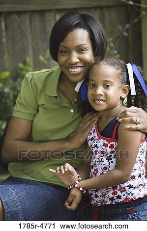 Portrait of mother hugging her daughter View Large Photo Image Stock Image - Portrait of mother hugging her daughter. Fotosearch