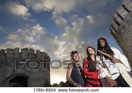 Portrait of pirates armed with a pistol and a sword with castle turrets and parapets in the background View Large Photo Image Picture - Portrait of pirates armed with a pistol and a sword with castle turrets and parapets in the background. Fotosearch