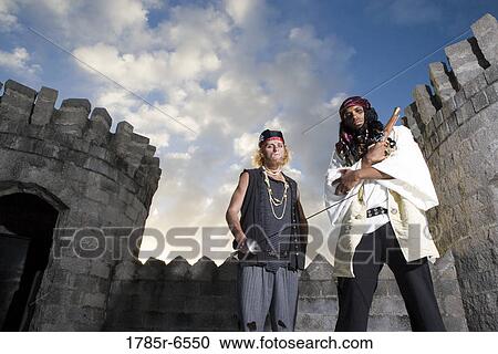 Portrait of pirates armed with a pistol and a sword with castle turrets and parapets in the background View Large Photo Image Stock Image - Portrait of pirates armed with a pistol and a sword with castle turrets and parapets in the background. Fotosearch