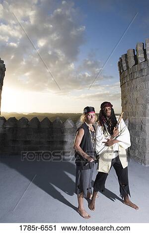 Portrait of pirates armed with a pistol and a sword with castle turrets and parapets in the background View Large Photo Image Stock Image - Portrait of pirates armed with a pistol and a sword with castle turrets and parapets in the background. Fotosearch