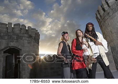 Portrait of pirates armed with a pistol and a sword with castle turrets and parapets in the background View Large Photo Image Stock Image - Portrait of pirates armed with a pistol and a sword with castle turrets and parapets in the background. Fotosearch