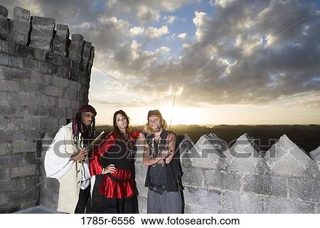 Portrait of pirates armed with a pistol and a sword with castle turrets and parapets in the background View Large Photo Image Stock Photograph - Portrait of pirates armed with a pistol and a sword with castle turrets and parapets in the background. Fotosearch