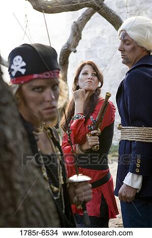 Portrait of pirates holding and threatening a captive navy officer with a sword and a gun View Large Photo Image Picture - Portrait of pirates holding and threatening a captive navy officer with a sword and a gun. Fotosearch