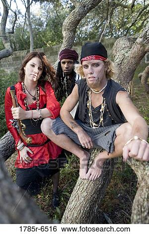 Portrait of pirates sitting on a tree trunk View Large Photo Image Stock Photograph - Portrait of pirates sitting on a tree trunk. Fotosearch