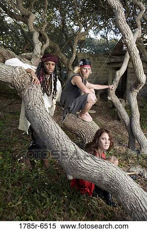 Portrait of pirates sitting on a tree trunk View Large Photo Image Stock Photography - Portrait of pirates sitting on a tree trunk. Fotosearch