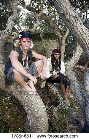 Portrait of pirates sitting on tree trunks View Large Photo Image Stock Image - Portrait of pirates sitting on tree trunks. Fotosearch