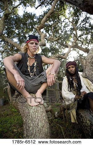 Stock Image - Portrait of pirates sitting on tree trunks. Fotosearch