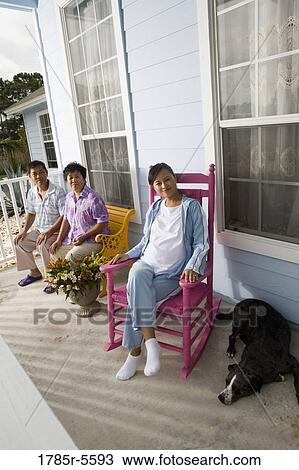 Portrait of pregnant woman sitting on rocking chair with her parents seated in background View Large Photo Image Stock Image - Portrait of pregnant woman sitting on rocking chair with her parents seated in background. Fotosearch