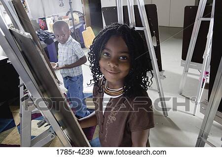 Portrait of students drawing on easels in art class View Large Photo Image Stock Photo - Portrait of students drawing on easels in art class. Fotosearch