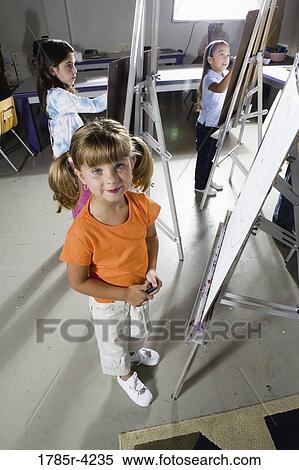 Portrait of students drawing on easels in art class View Large Photo Image Stock Photography - Portrait of students drawing on easels in art class. Fotosearch