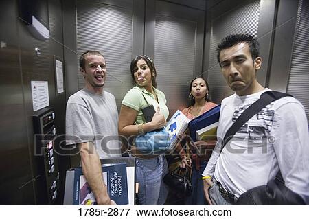 Portrait of students making funny faces in an elevator View Large Photo Image Stock Photo - Portrait of students making funny faces in an elevator. Fotosearch