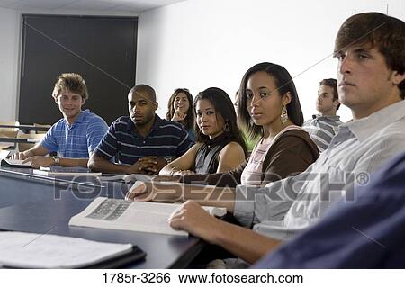 Stock Photograph - Portrait of students sitting in the classroom. Fotosearch