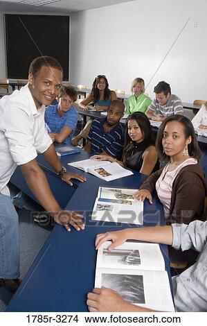 Picture - Portrait of Teacher and students in the classroom. Fotosearch