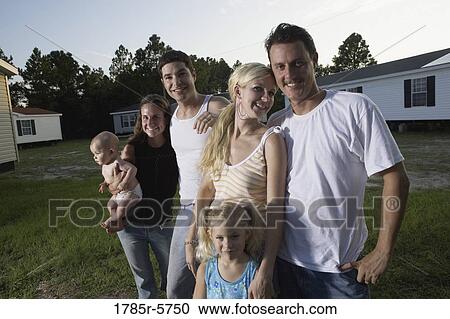 Portrait of two blue-collar families standing in front of trailer homes View Large Photo Image Stock Image - Portrait of two blue-collar families standing in front of trailer homes. Fotosearch