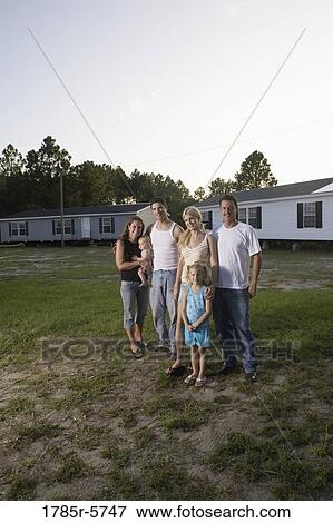 Portrait of two blue-collar families standing in front of trailer homes View Large Photo Image Stock Photo - Portrait of two blue-collar families standing in front of trailer homes. Fotosearch