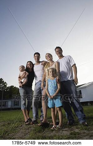 Portrait of two blue-collar families standing in front of trailer homes View Large Photo Image Stock Photo - Portrait of two blue-collar families standing in front of trailer homes. Fotosearch