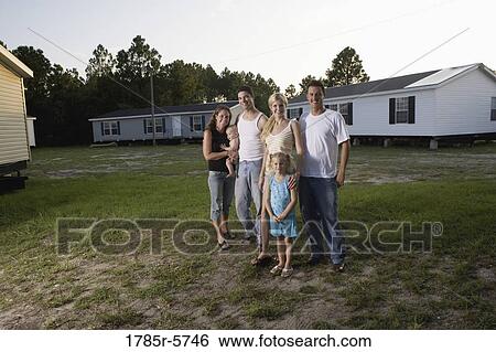 Portrait of two blue-collar families standing in front of trailer homes View Large Photo Image Stock Photograph - Portrait of two blue-collar families standing in front of trailer homes. Fotosearch