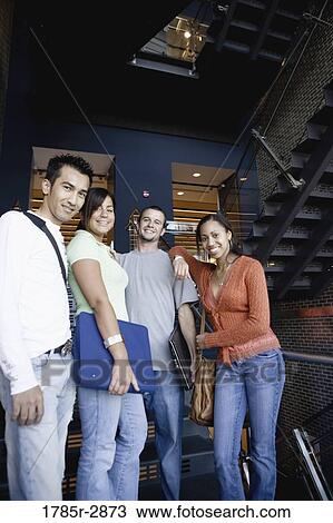Stock Image - Portrait of university students hanging out between classes. Fotosearch