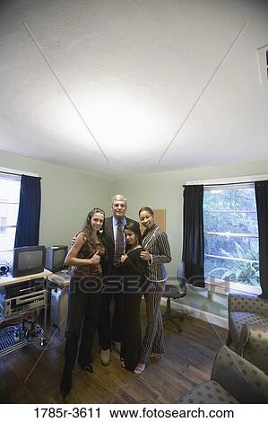 Stock Image - Portrait of women entrepreneurs with investor in an office. Fotosearch