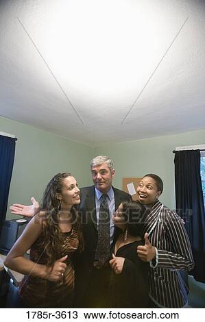 Stock Image - Portrait of women entrepreneurs with investor in an office. Fotosearch