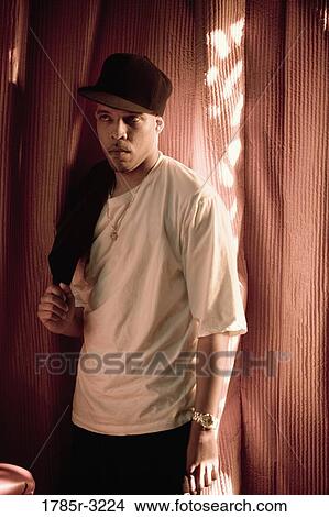 Portrait of young man in hip-hop fashion View Large Photo Image Picture - Portrait of young man in hip-hop fashion. Fotosearch