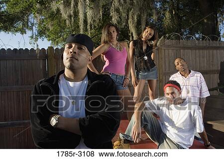 Portrait of young men and women in hip-hop fashion outside View Large Photo Image Stock Photo - Portrait of young men and women in hip-hop fashion outside. Fotosearch