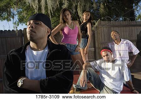 Portrait of young men and women in hip-hop fashion outside View Large Photo Image Stock Photo - Portrait of young men and women in hip-hop fashion outside. Fotosearch