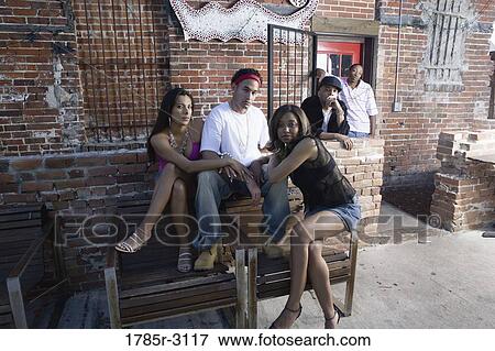 Portrait of young men and women in hip-hop fashion hanging out in a back alley View Large Photo Image Stock Photo - Portrait of young men and women in hip-hop fashion hanging out in a back alley. Fotosearch
