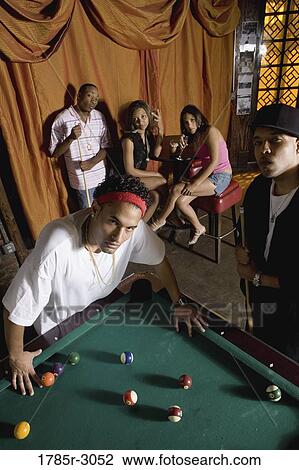 Portrait of young men in hip-hop fashion leaning against pool table View Large Photo Image Stock Image - Portrait of young men in hip-hop fashion leaning against pool table. Fotosearch