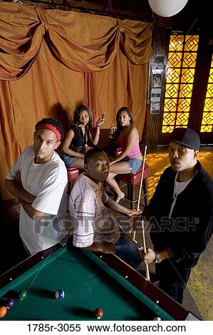 Portrait of young men in hip-hop fashion leaning against pool table View Large Photo Image Stock Photography - Portrait of young men in hip-hop fashion leaning against pool table. Fotosearch