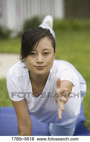 Portrait of young pregnant Asian woman exercising View Large Photo Image Stock Photo - Portrait of young pregnant Asian woman exercising. Fotosearch