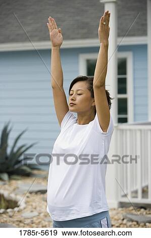 Portrait of young pregnant Asian woman doing stretching exercises View Large Photo Image Stock Photo - Portrait of young pregnant Asian woman doing stretching exercises. Fotosearch