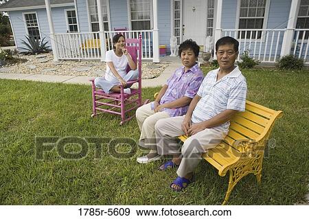 Pregnant woman and her parents seated in front lawn of house View Large Photo Image Stock Photo - Pregnant woman and her parents seated in front lawn of house. Fotosearch