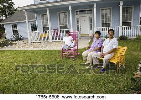 Pregnant woman and her parents seated in front lawn of house View Large Photo Image Stock Photograph - Pregnant woman and her parents seated in front lawn of house. Fotosearch