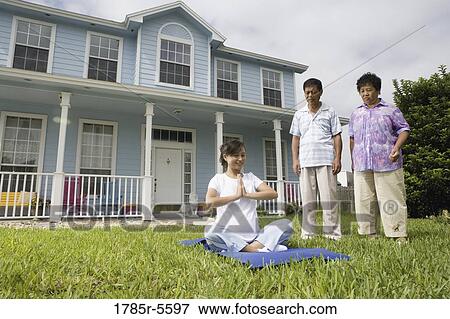 Pregnant woman in a yoga position while her parents stand by and watch View Large Photo Image Stock Photo - Pregnant woman in a yoga position while her parents stand by and watch. Fotosearch