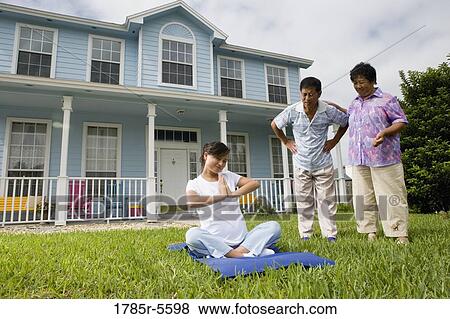 Pregnant woman in a yoga position while her parents stand by and watch View Large Photo Image Stock Photo - Pregnant woman in a yoga position while her parents stand by and watch. Fotosearch