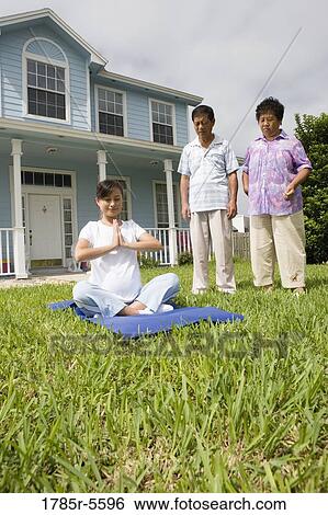 Pregnant woman in a yoga position while her parents stand by and watch View Large Photo Image Stock Photograph - Pregnant woman in a yoga position while her parents stand by and watch. Fotosearch