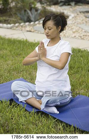 Pregnant woman in yoga position on lawn View Large Photo Image Picture - Pregnant woman in yoga position on lawn. Fotosearch